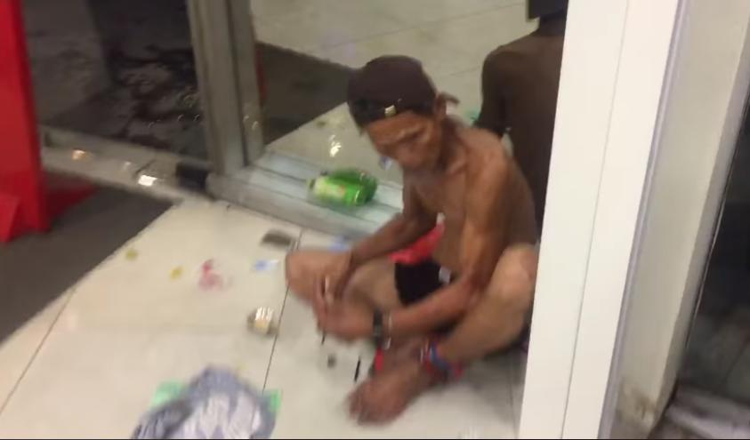 A screengrab of the incident shows the man openly taking drugs, reportedly at an ATM in Bukit Bintang. — Screengrab courtesy of Genji Buskers Facebook