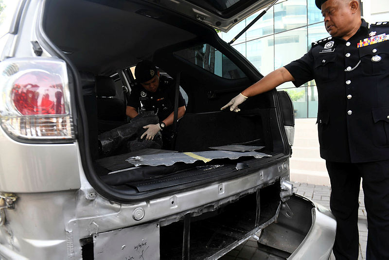 Bukit Aman Narcotics CID acting director Datuk Kamarulzaman Mamat shows the parts of a car in which drug were hidden. — Bernama