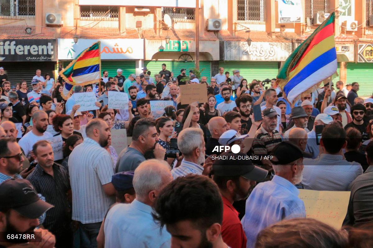 Syrians gather to protest the humanitarian situation in the predominantly Druze city of Sweida on July 28, 2025. - Shadi AL-DUBAISI / AFP