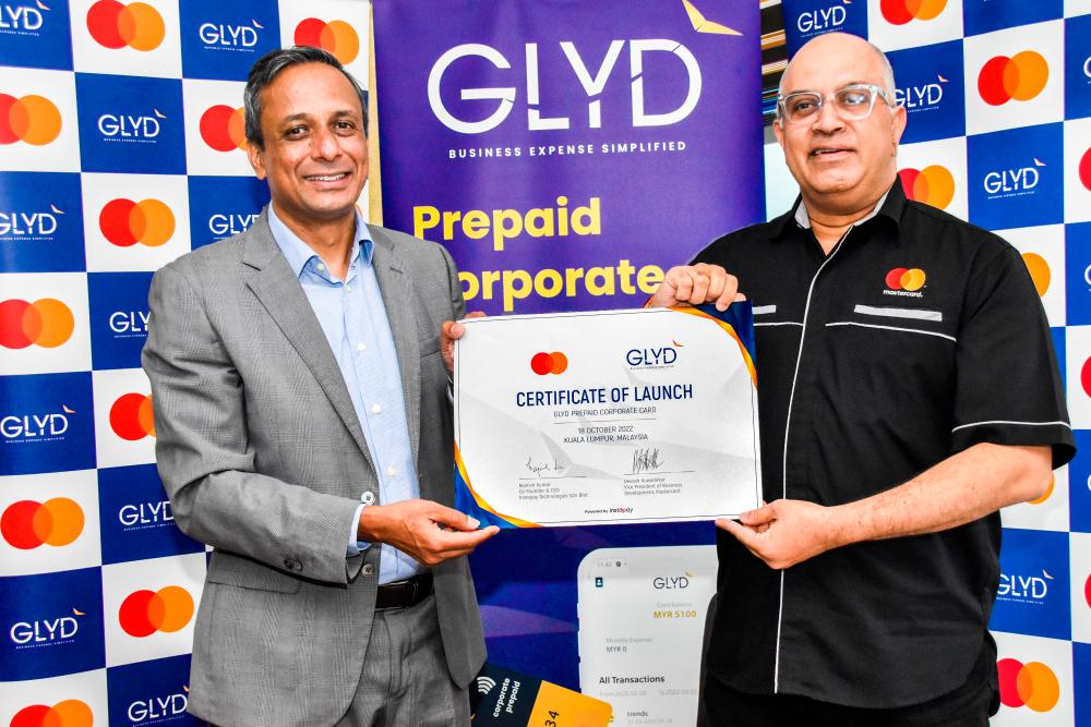 Rajnish (left) and Mastercard vice president of business development Devesh Kuwadekar presenting the Certificate of Launch between Glyd and Mastercard.