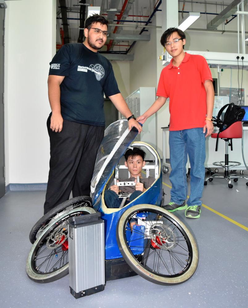 Team leader Vincent Tantio, 22, in the cockpit, with teammates Amaresh Choudury Malakar, 22 (left) and Jason Wong Yuen Sung, 22. All three are the university’s mechanical engineering students. The car is not fully-assembled yet and hence the wheels and battery pack (foreground) are not attached to it.