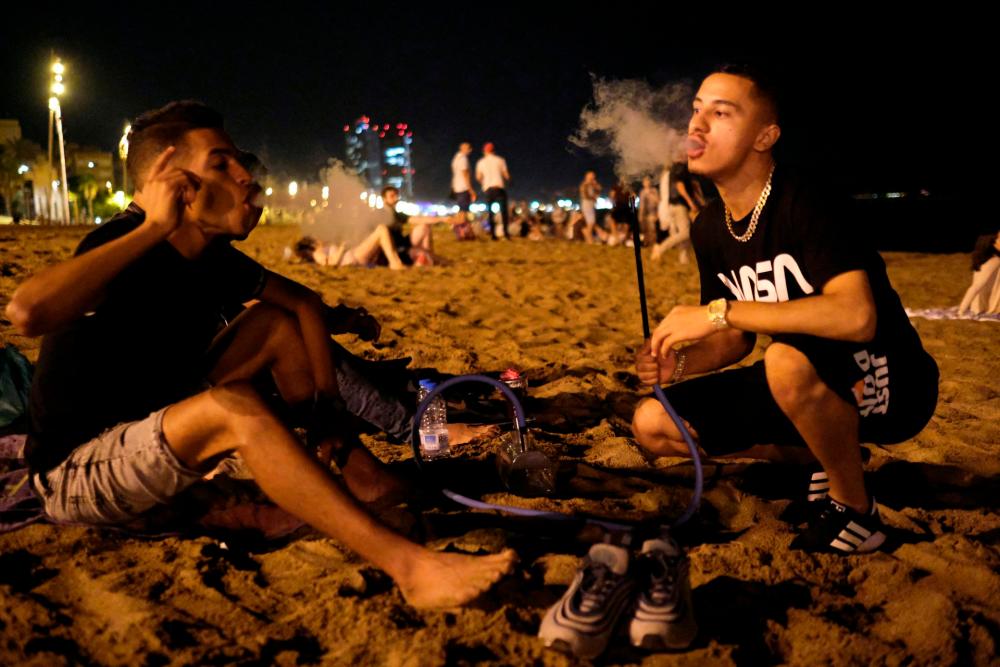 People enjoy the beach at night in the Barceloneta neighbourhood, after Catalonia’s regional authorities announced restrictions to contain the spread of the coronavirus disease (Covid-19) in Barcelona, Spain August 9, 2020. REUTERSPIX