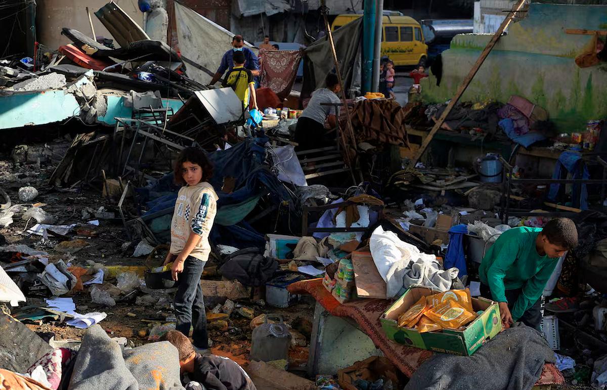 Palestinians inspect the damage at a school sheltering displaced people, following an Israeli strike, in Gaza City, May 26, 2025. REUTERS/Dawoud Abu Alkas/File Photo