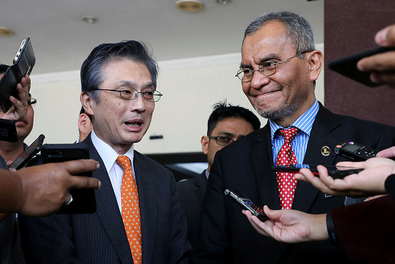 Japanese ambassador to Malaysia Hiroshi Oka (L) and Health Minister Dzulkefly Ahmad speak to members of media after visiting Japanese badminton player Kento Momota who was injured in a pre-dawn vehicle collision in Putrajaya, Malaysia, Jan 13, 2020. — AFP