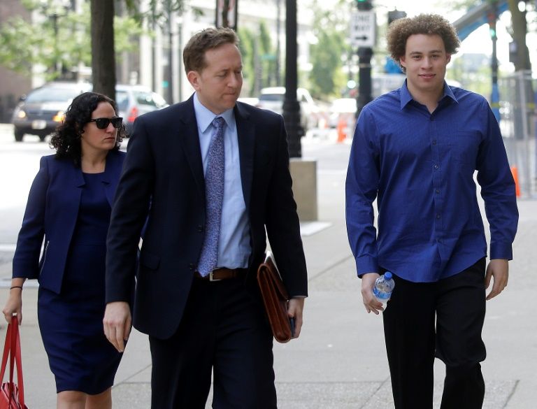 Marcus Hutchins (R), seen ahead of a 2017 court appearance, was hailed as a hero for stemming the WannaCry ransomware outbreak but later charged in the US with creating malware that could attack the banking system. — AFP