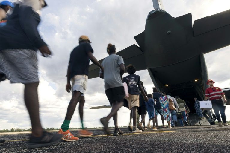 Residents of McArthur River, a remote town in the Northern Territory, boarding an Australian military plane as authorities evacuate communities in the path of a powerful cyclone. — AFP