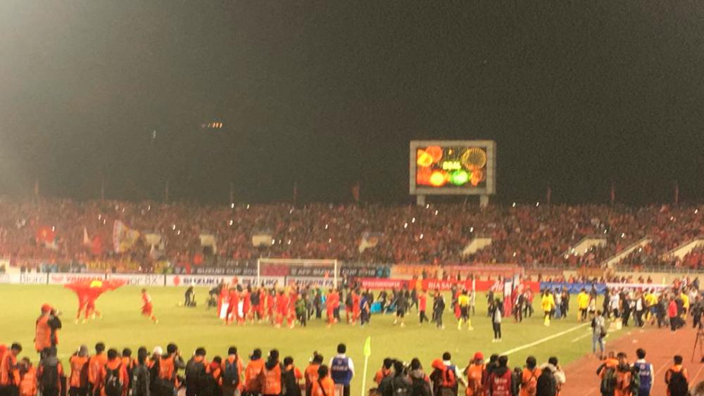 Vietnam players running to their fan to celebrate their victory against Malaysia.