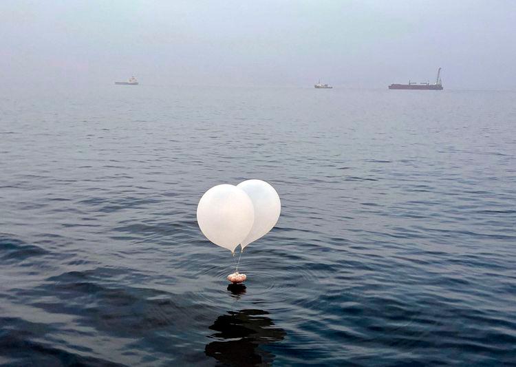 A balloon carrying various objects including what appeared to be trash, believed to have been sent by North Korea, is pictured at the sea off Incheon, South Korea - REUTERSpix