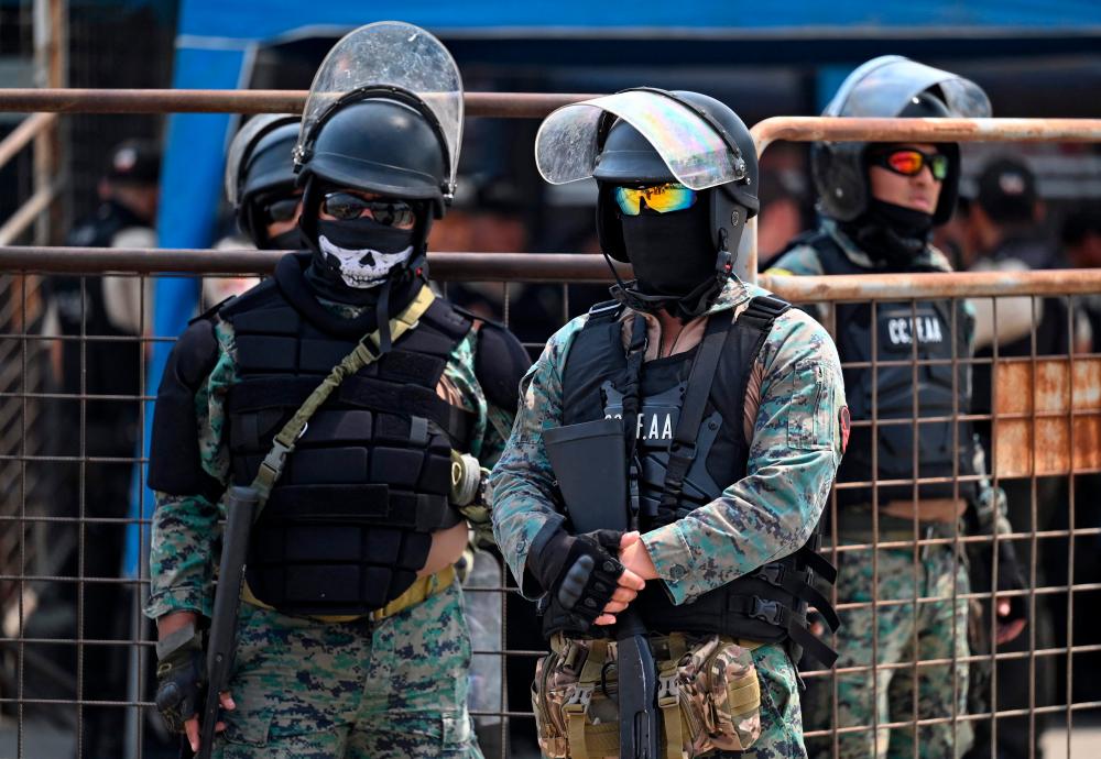 Members of the Armed Forces stand guard outside the Litoral Penitentiary in Guayaquil, Ecuador, on November 1, 2022, as inmates are being transferred. AFPPIX