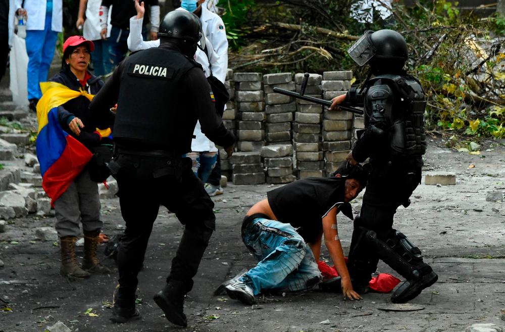 Riot police arrest a demonstrator in the surroundings of El Arbolito park in Quito on June 24, 2022, in the framework of indigenous-led protests against the government. AFPPIX