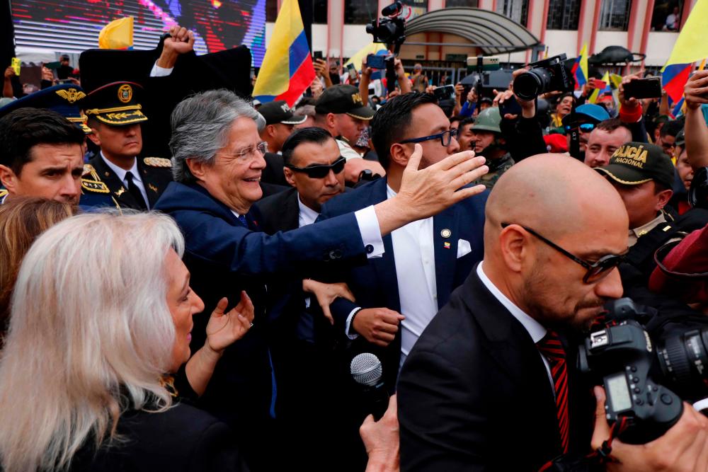 Ecuador’s President Guillermo Lasso greets supporters upon arrival to the Assembly building in Quito on May 16, 2023/AFPPix