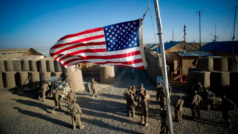 The American flag flies at half mast to remember the victims of 9/11 at Forward Operating Base (FOB) Kuschamond, Afghanistan on September 11, 2011. — AFP