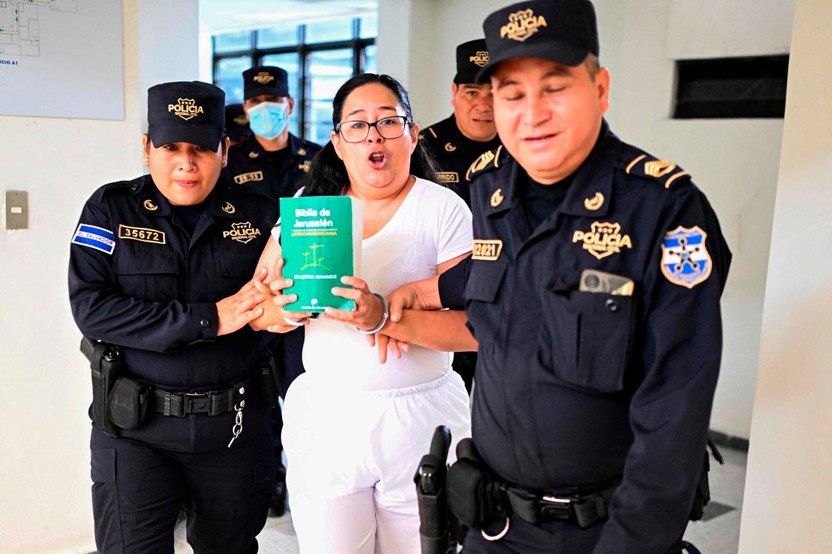 Salvadoran lawyer and human rights activist Ruth Lopez is escorted by police to a hearing at the Isidro Menéndez judicial centre in San Salvador on June 4, 2025. Lopez was arrested on May 18 and accused of embezzling state funds when she worked for an electoral court a decade ago. A vocal critic of Bukele's anti-crime policy, she worked for a rights group that was investigating alleged state corruption and assisting Venezuelans deported by the United States and imprisoned in El Salvador. - Marvin RECINOS / AFP