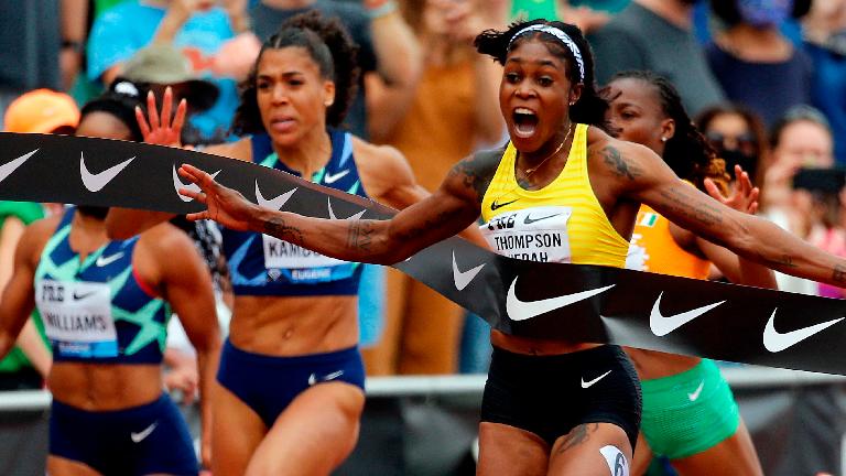 Elaine Thompson-Herah of Jamaica (right) celebrates winning the 100m race during the Wanda Diamond League Prefontaine Classic at Hayward Field on Saturday in Eugene, Oregon – AFPPIX