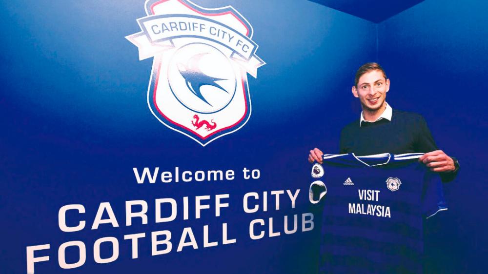 Cardiff City’s new signing Argentinian striker Emiliano Sala holds the team’s jersey after his unveiling.