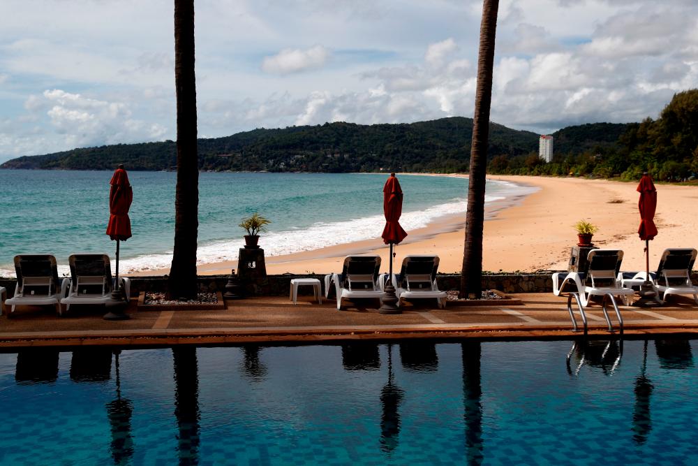 An empty hotel, which is open for business, and beach in Karon, Phuket Island in March. Tourism is expected to return to normal only in 2026. – REUTERSPIX