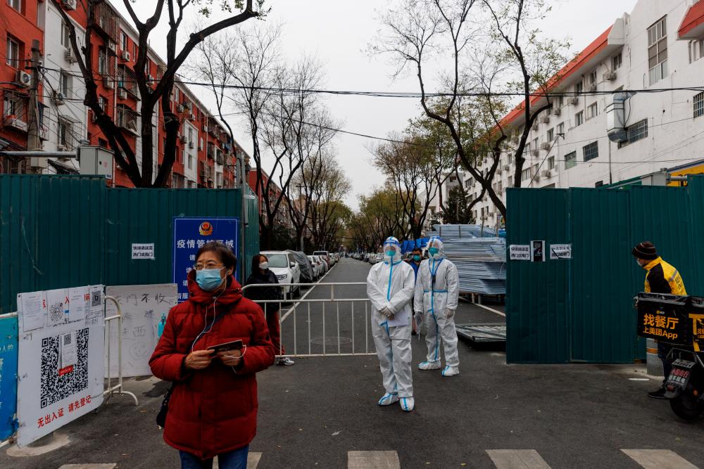 Epidemic-prevention workers standing guard at a residential compound in Beijing on Monday. – Reuterspic
