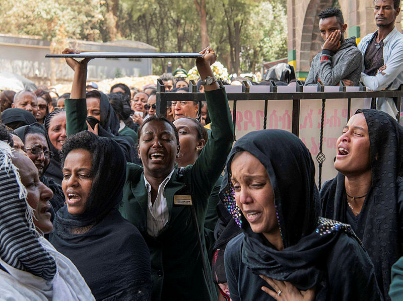 Ethiopian Airlines crew members mourn as pallbearers carry the coffins of their colleagues of the Ethiopian Airline Flight ET 302 plane crash, during the burial ceremony at the Holy Trinity Cathedral Orthodox church in Addis Ababa, Ethiopia, March 17, 2019. — AFP