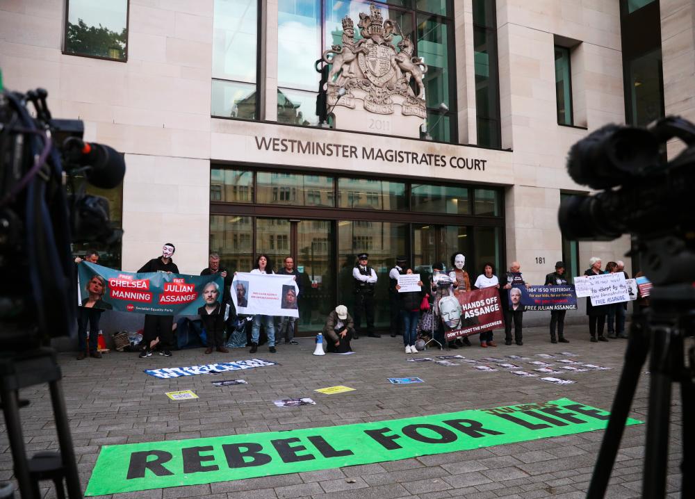 Demonstrators protest outside of Westminster magistrates court, where a case hearing for US extradition of Wikileaks founder Julian Assange is held, in London, Britain, June 14, 2019. - Reuters