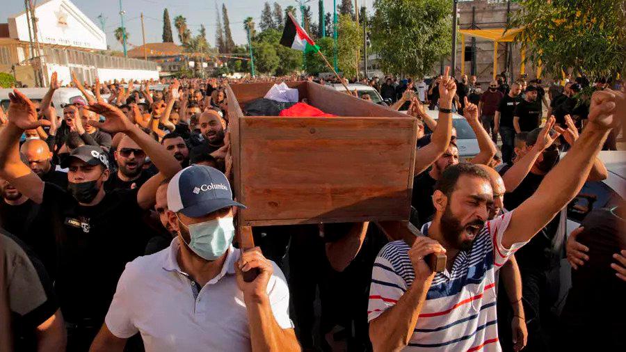 Arab Israelis hold a funeral for Mousa Hassouna who was killed during clashes with Israeli security forces during a demonstration. — AFP