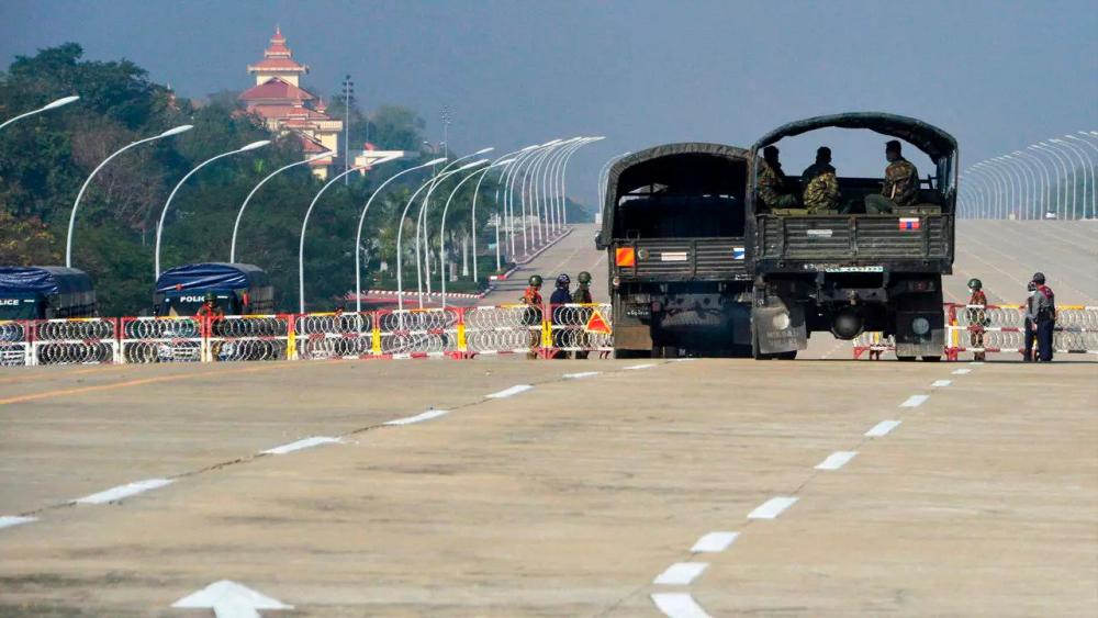 Soldiers stand guard along a blockaded road near Myanmar’s parliament in the capital Naypyidaw. — AFP
