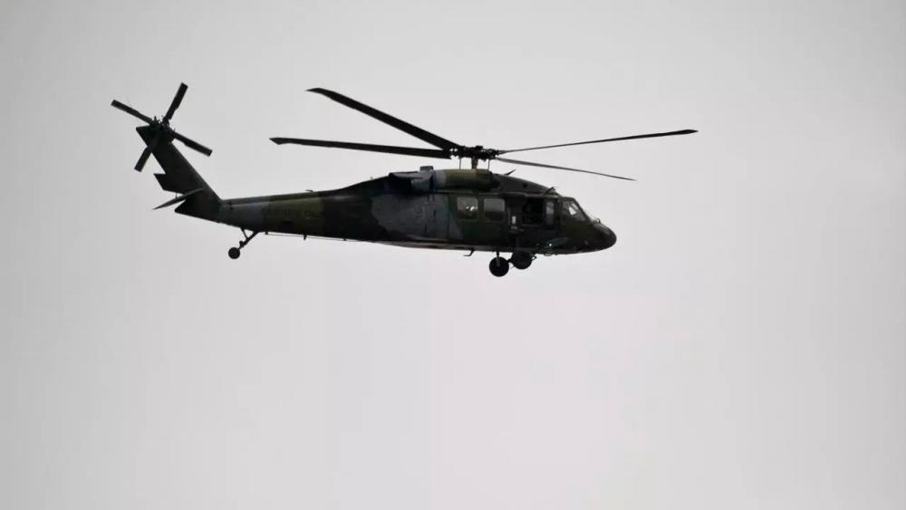 A Colombian Army Black Hawk helicopter flies over an area where a FARC guerrillas attack took place in Cali, Colombia, in April 2015. — AFP