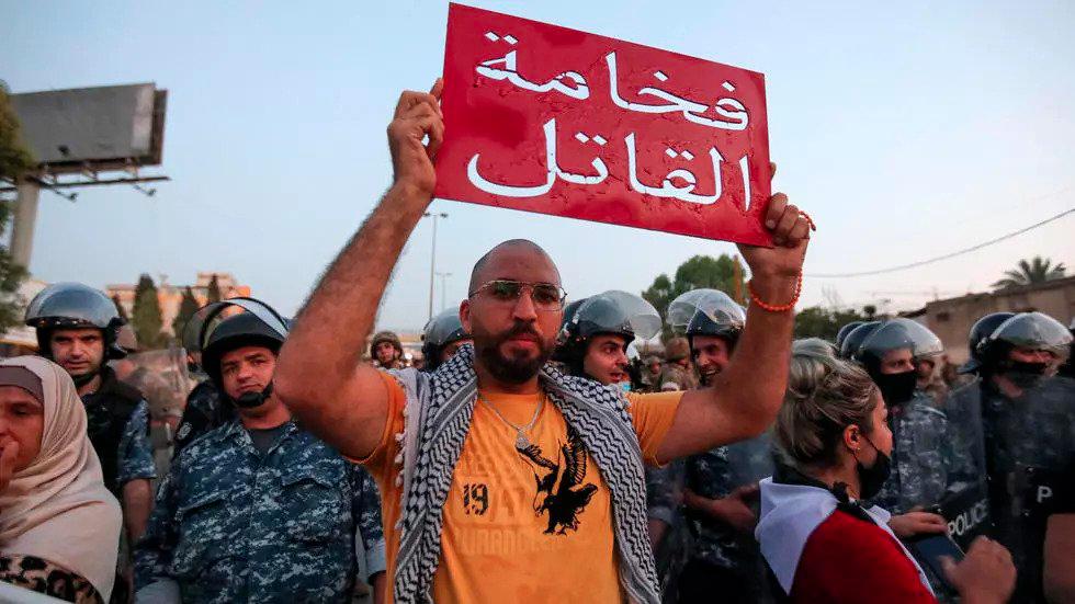 A Lebanese protester holds a banner that reads in Arabic “Your highness the murderer” in a Sept 2020 protest demanding progress in an investigation into a deadly port blast. — AFP