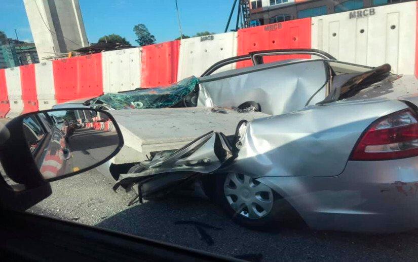 Woman cheats death after part of tower crane falls on car