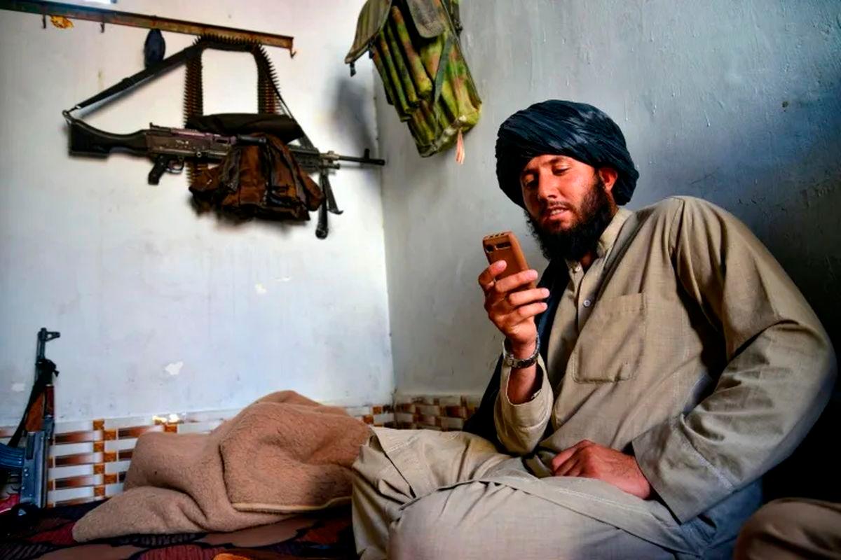 A Taliban security personnel uses a non-smartphone in Kandahar on June 17, 2025 (Sanaullah SEIAM) (Sanaullah SEIAM/AFP/AFP)