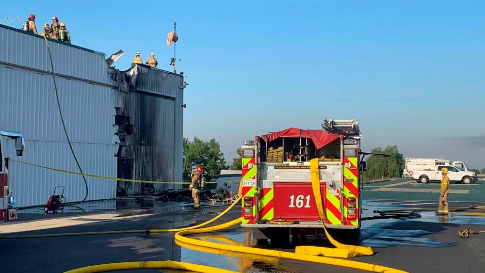 Fire department personnel responding after a small plane crashed into a hanger at Cable Airport in Upland, California. Pix credit: San Bernardino County Fire Department.