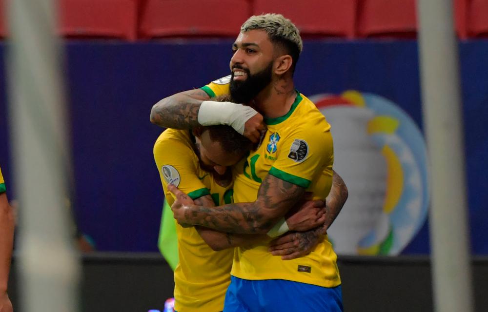 Brazil’s Gabriel Barbosa (Right) celebrates with teammate Neymar after scoring against Venezuela during the Conmebol Copa America 2021 football tournament group phase match at Brasilia. – AFPPIX