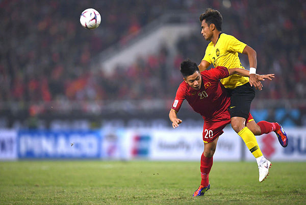 Vietnam’s forward Phan Van Duc (L) and defender Aidil Zafuan fight for the ball during the AFF Suzuki Cup 2018 final football match between Vietnam and Malaysia at the My Dinh Stadium in Hanoi on Dec 15, 2018. — AFP