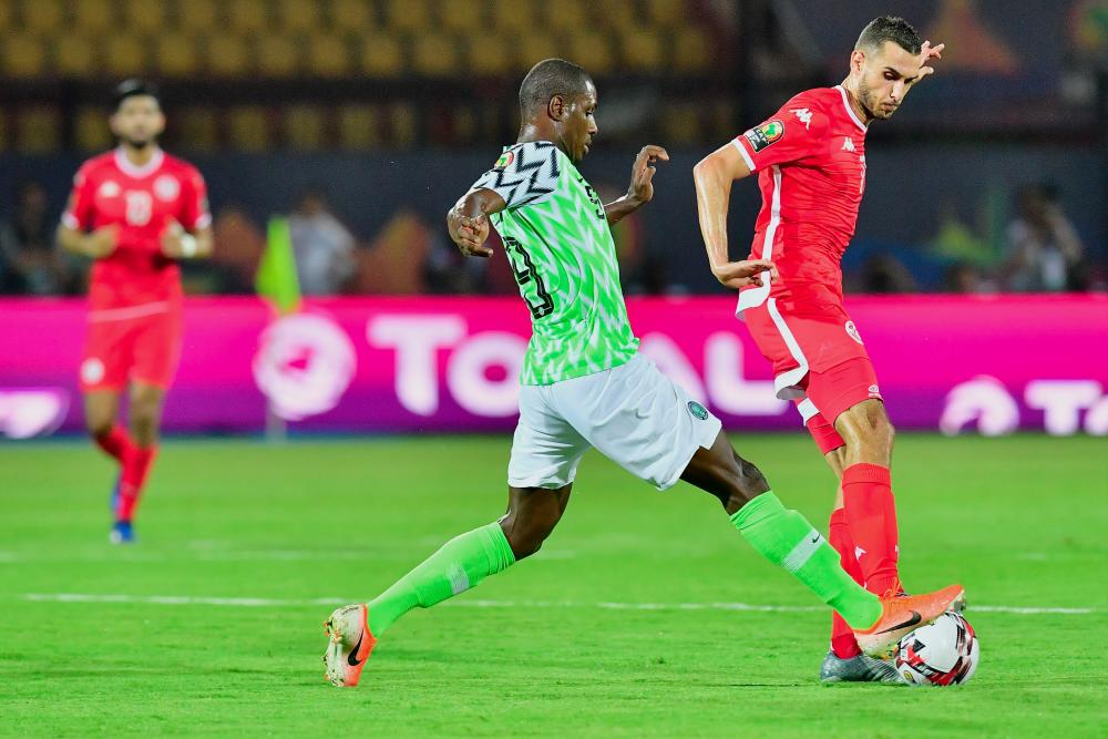 Nigeria’s forward Odion Ighalo is marked by Tunisia’s midfielder Ellyes Skhiri during the 2019 Africa Cup of Nations (CAN) third place play-off football match between Tunisia and Nigeria at the Al Salam stadium in Cairo on July 17, 2019. — AFP