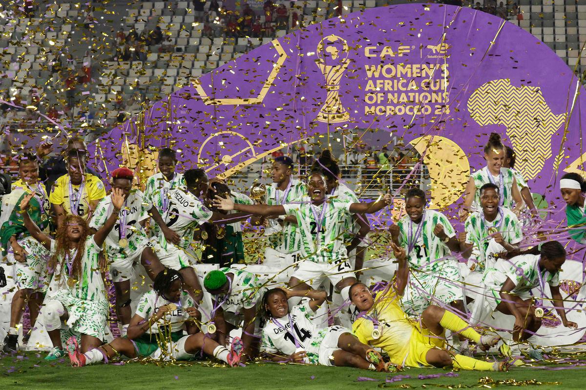 Nigeria’s players celebrate with the trophy on the podium after winning the 2025 Women’s Africa Cup of Nations final football match against Morocco at Prince Moulay Abdellah Stadium in Rabat on July 26, 2025. Photo by Abdel Majid BZIOUAT / AFPpix