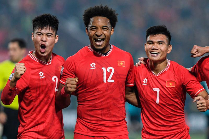 (L-R) Vietnam's Duy Manh Do, Xuan Son Nguyen and Xuan Manh Pham celebrate after their team's win in the 2024 ASEAN Electric Cup Semi-final second leg football match between Vietnam and Singapore at the Viet Tri Stadium in Phu Tho province on December 29, 2024. -HOANG Anh / AFP