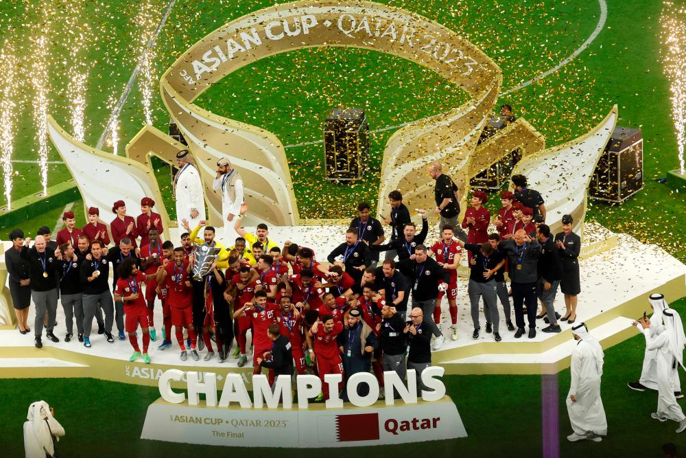 Qatar’s players celebrate with the Qatar 2023 AFC Asian Cup trophy during the podium ceremony after the final football match between Jordan and Qatar at the Lusail Stadium in Lusail, north of Doha on February 10, 2024/AFPpix