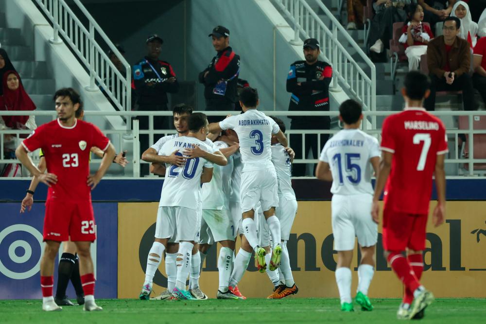 Uzbekistan's players celebrate following the own-goal scored by Indonesia during the U23 AFC Qatar 2024 Asian Cup semi-final match between Indonesia and Uzbekistan at Abdullah Bin Khalifa Stadium in Doha on April 29, 2024. - AFPPIX