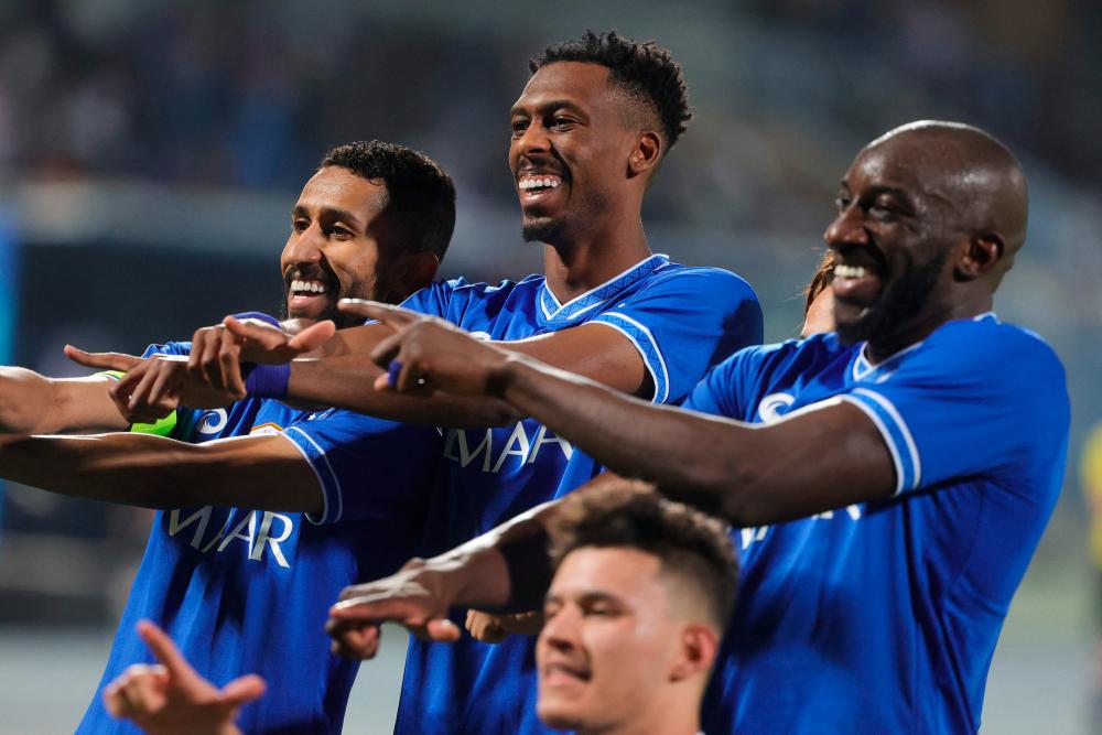 Hilal’s midfielder Mohamed Kanno (C) celebrates with teammates scoring their second goal during the AFC Champions League group A match between Qatar’s Al-Rayyan and Saudi Arabia’s Al-Hilal on April 11, 2022, at the Prince Faisal Bin Fahd stadium in the capital Riyadh. AFPPIX