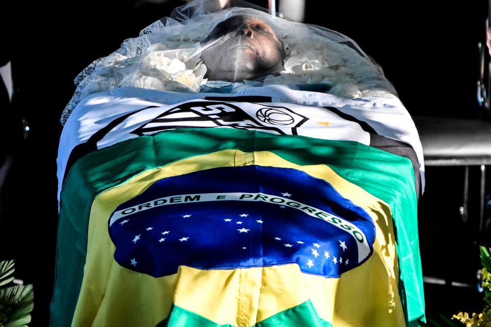 A flag of Brazil and a flag of Santos are seen on top of the coffin of Brazilian football legend Pele during his wake at the Urbano Caldeira stadium in Santos, Sao Paulo, Brazil, on January 2, 2023/AFPPix