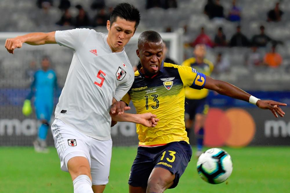 Japan’s Naomichi Ueda (L) and Ecuador’s Enner Valencia vie for the ball during their Copa America football tournament group match at the Mineirao Stadium in Belo Horizonte, Brazil, on June 24, 2019. — AFP