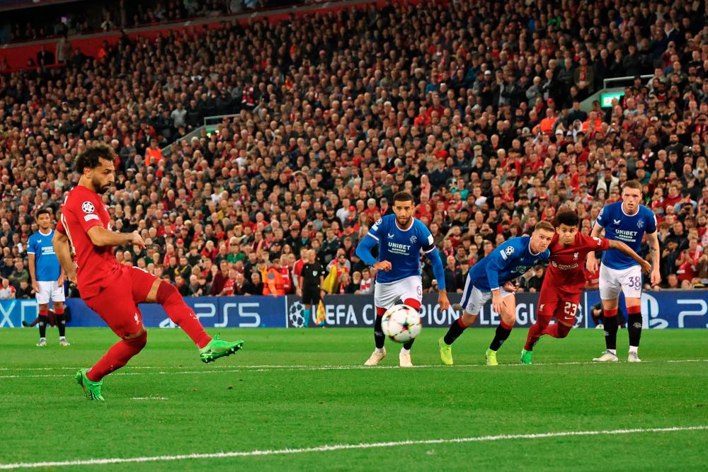 Liverpool's Egyptian striker Mohamed Salah (L) shoots from the penalty spot to score their second goal during UEFA Champions League group A football match between Liverpool and Glasgow Rangers at Anfield in Liverpool, north west England on October 4, 2022. AFPPIX