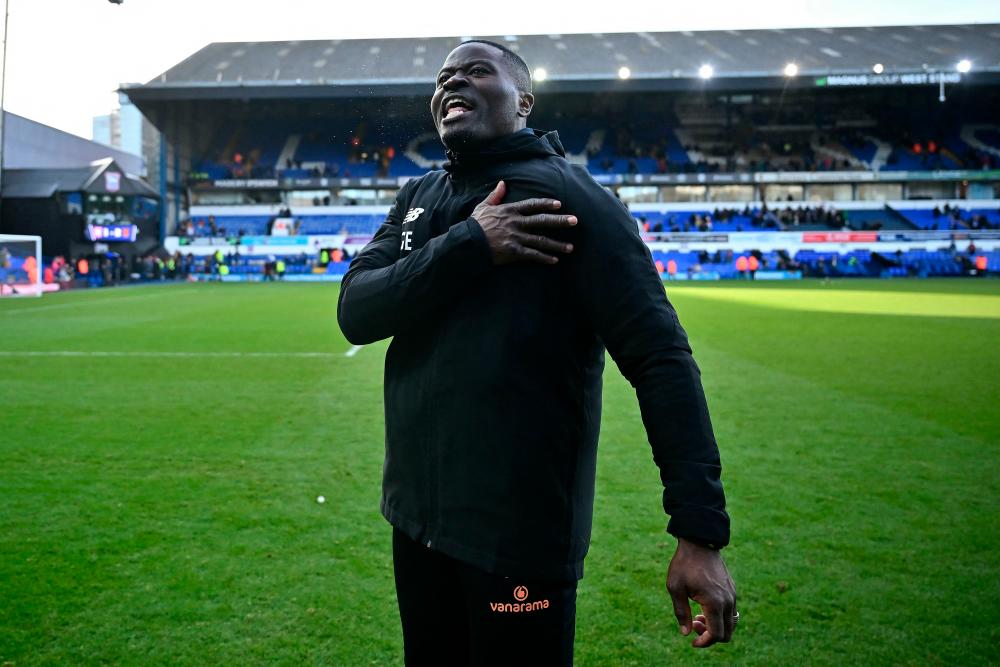 Maidstone’s Cameroonian manager George Elokobi celebrates after winning the English FA Cup fourth round football match between Ipswich Town and Maidstone United at Portman Road, Ipswich, eastern England on January 27, 2024/AFPPix