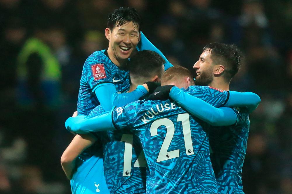 Tottenham Hotspur's South Korean striker Son Heung-Min (L) celebrates with teammates after scoring their second goal during the English FA Cup fourth round football match between Preston North End and Tottenham Hotspur at Deepdale stadium in Preston, north-west England, on January 28, 2023. - AFPPIX