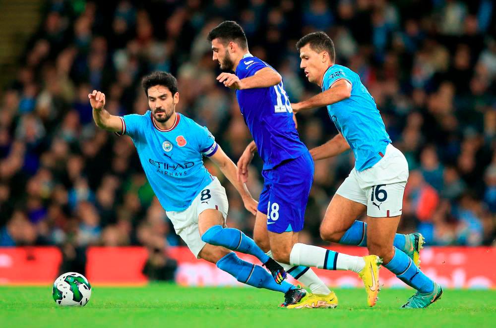 Manchester City’s German midfielder Ilkay Gundogan (L), Chelsea’s Albanian forward Armando Broja (C) and Manchester City’s Spanish midfielder Rodri (R) all vie for the ball during the English League Cup third round football match between Manchester City and Chelsea at the Etihad stadium in. AFPPIX
