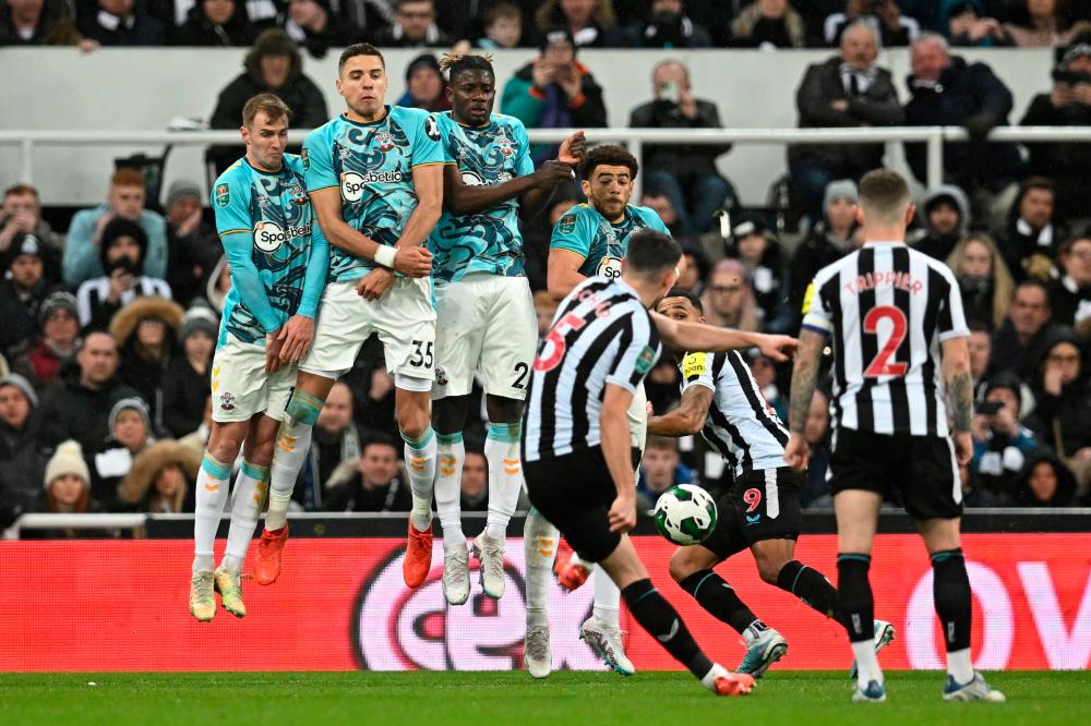 Newcastle United’s Swiss defender Fabian Schar (C) takes a free kick during the English League Cup semi final football match between Newcastle United and Southampton at St James’s Park stadium in Newcastle, on January 31, 2023/AFPPix