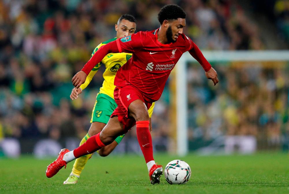 Gomez (right) runs with the ball during the English League Cup third round match at Carrow Road Stadium in Norwich, eastern England. – AFPPIX