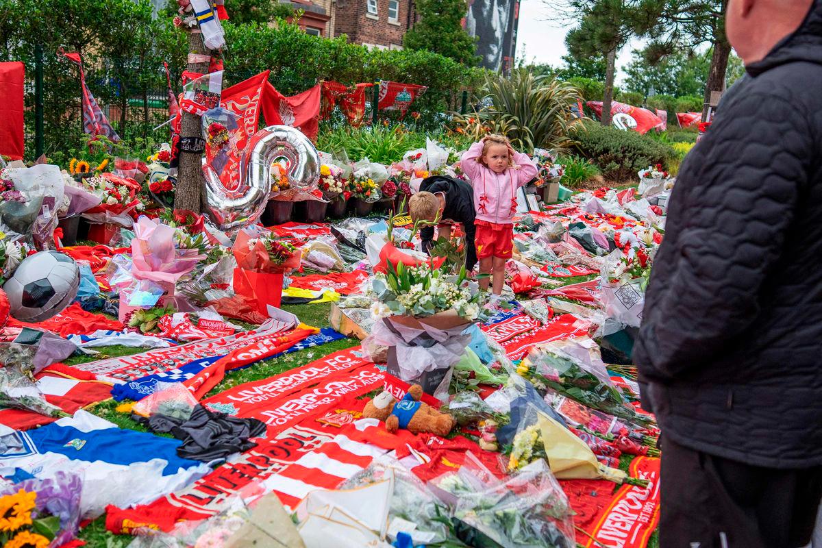 Well-wishers leave flowers, scarves and shirts at a memorial set up close to Anfield football ground for their Portuguese forward Diogo Jota in Liverpool, north-west England July 4, 2025 - AFP