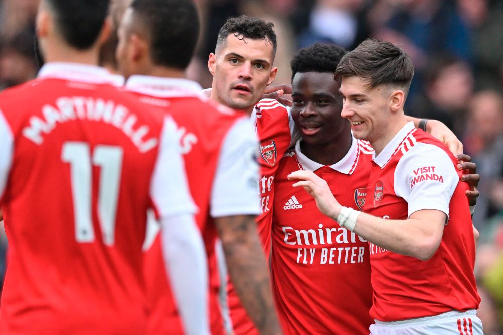 Arsenal's English midfielder Bukayo Saka (2R) celebrates with teammates after scoring their fourth goal during the English Premier League football match between Arsenal and Crystal Palace at the Emirates Stadium in London on March 19, 2023. AFPPIX