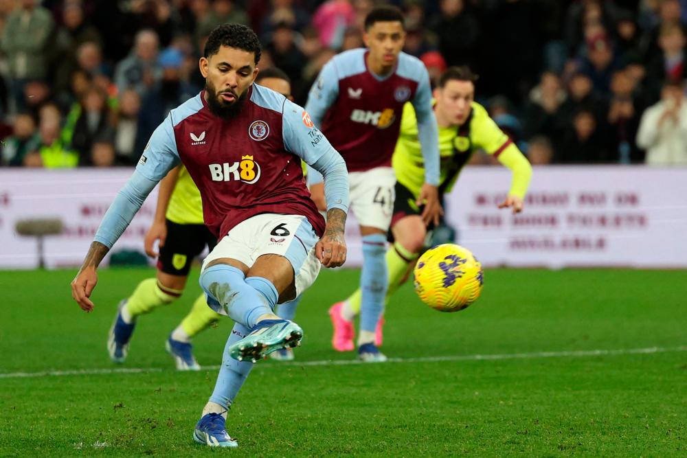 Aston Villa’s Brazilian midfielder #06 Douglas Luiz scores their third goal from the penalty spot during the English Premier League football match between Aston Villa and Burnley at Villa Park in Birmingham, central England on December 30, 2023/AFPPix