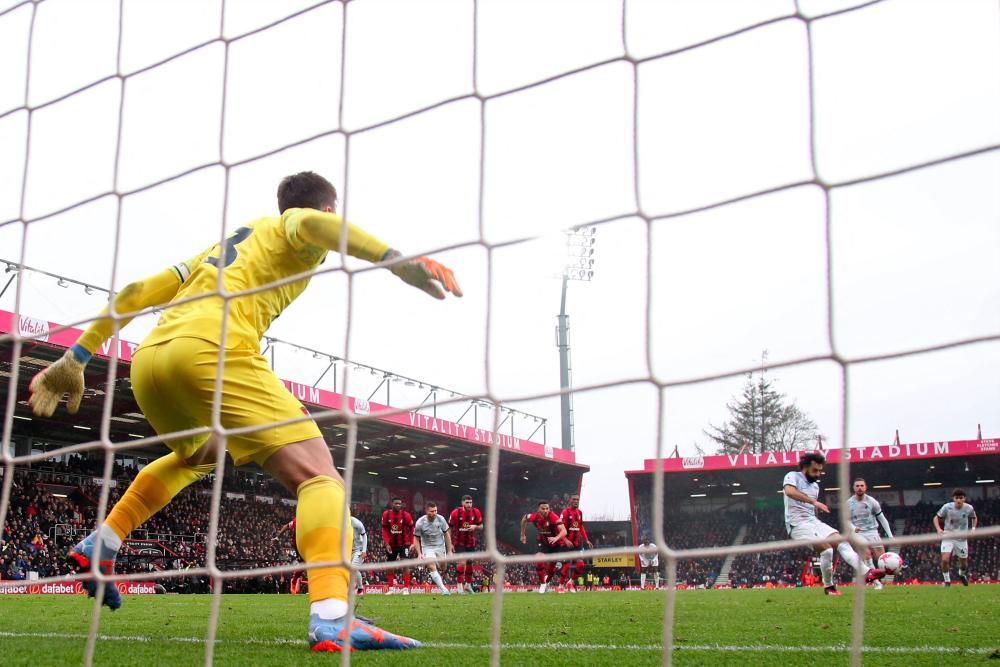 Liverpool's Egyptian striker Mohamed Salah (3R) hits this penalty kick wide of the Bournemouth goal during the English Premier League football match between Bournemouth and Liverpool at the Vitality Stadium in Bournemouth, southern England on March 11, 2023. - AFPPIX